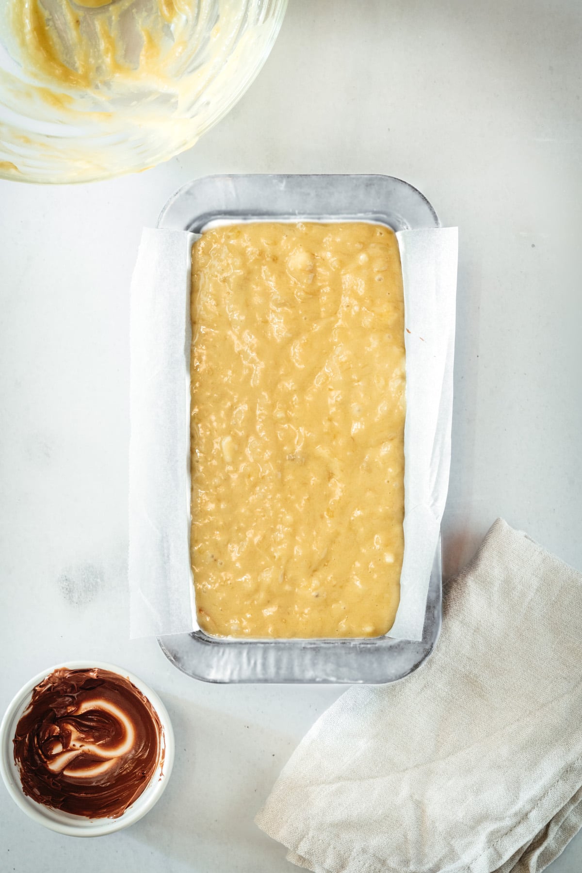 Overhead view of banana bread in pan before baking