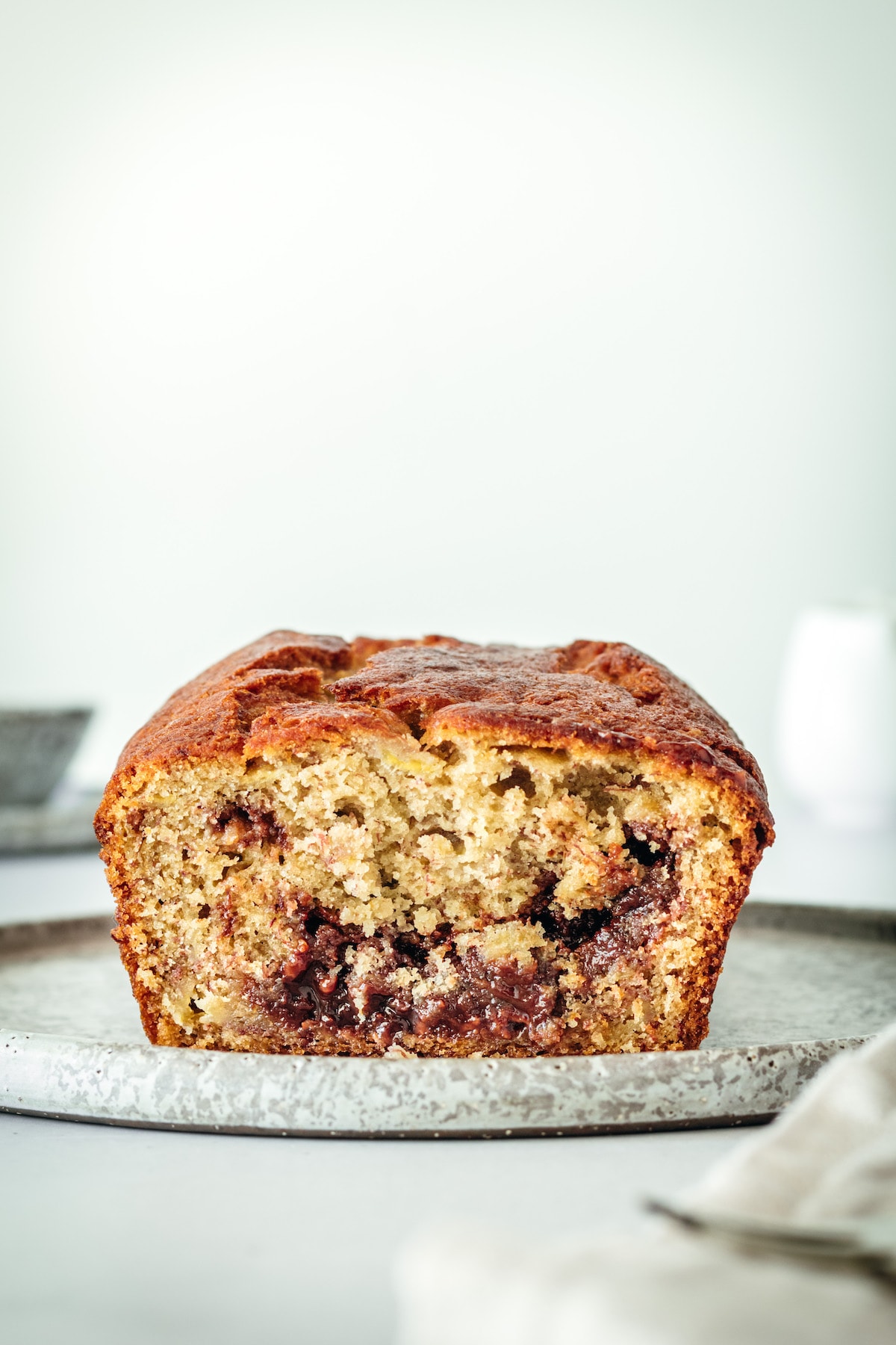 Cut loaf of banana bread on plate