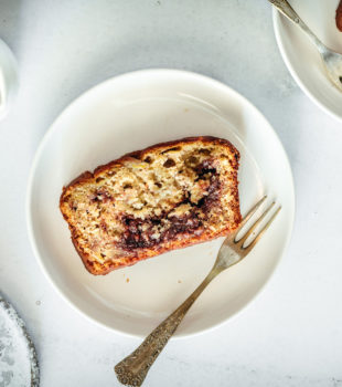 Overhead view of Nutella Banana Bread slice on plate with fork