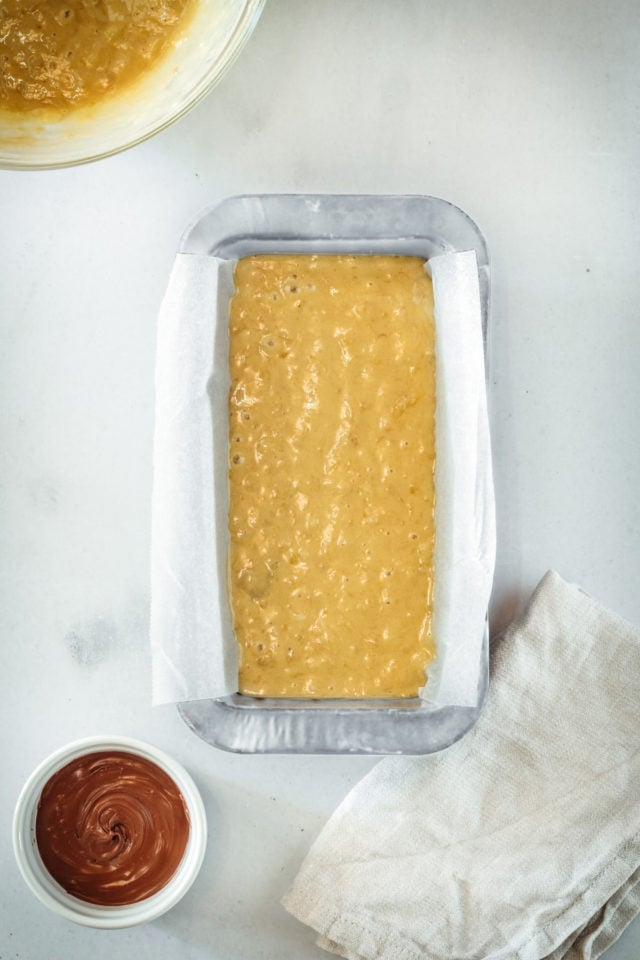 Overhead view of banana bread batter in loaf pan