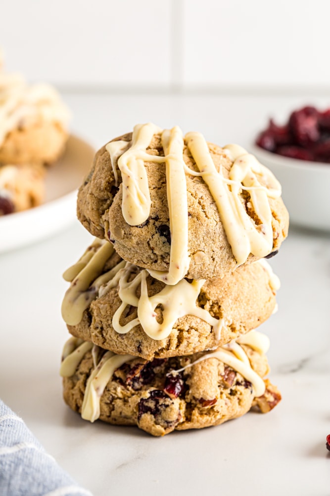 Stack of oatmeal cranberry cookies on a marble surface.