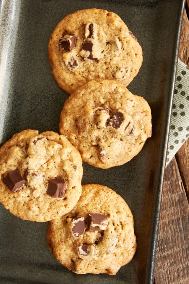 overhead view of Bourbon Pecan Chocolate Chip Cookies on a dark gray tray