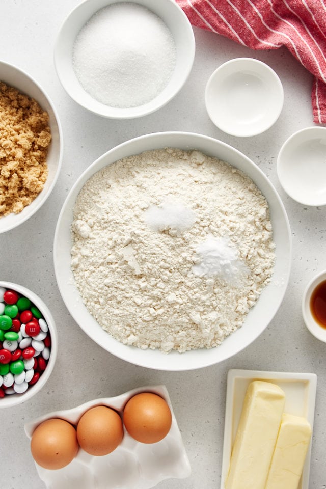 overhead view of flour, baking soda, and salt in a white mixing bowl