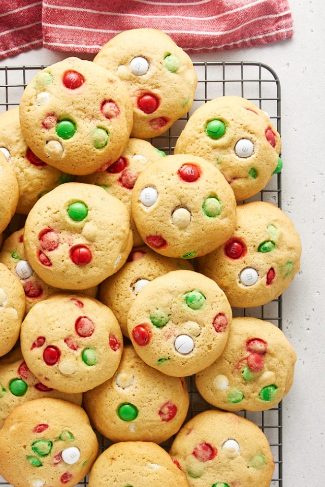 overhead view of Christmas M&M Cookies piled on a wire rack