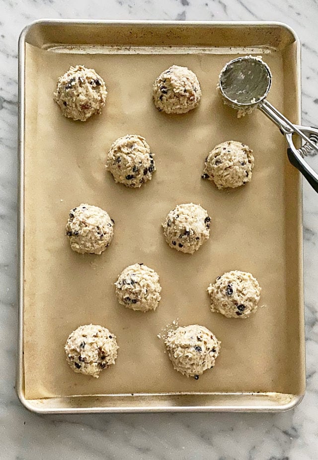 overhead view of Currant Oat Scones dough on a parchment-lined baking pan ready for the oven