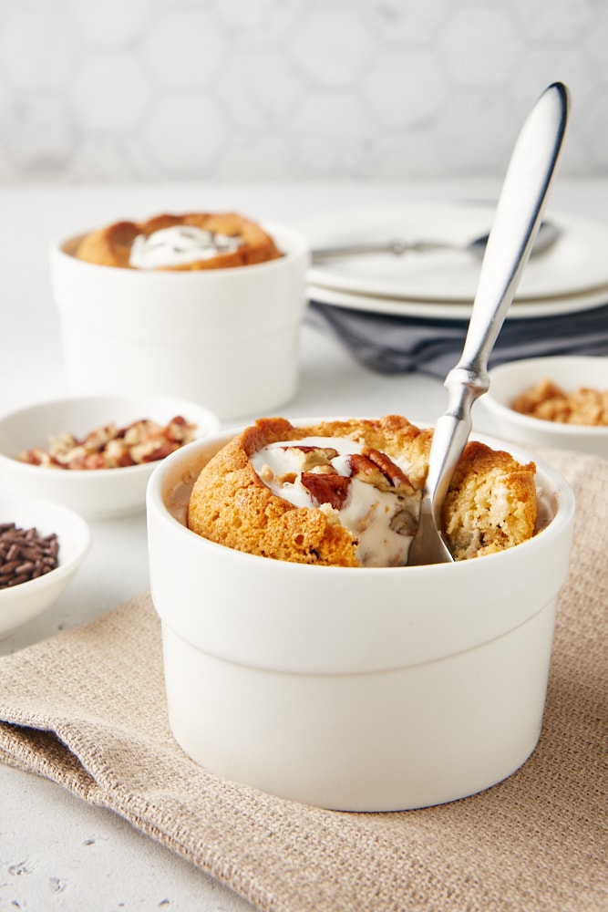 Deep Dish Chocolate Chip Cookies for two in white ramekins with a spoon sticking out of one