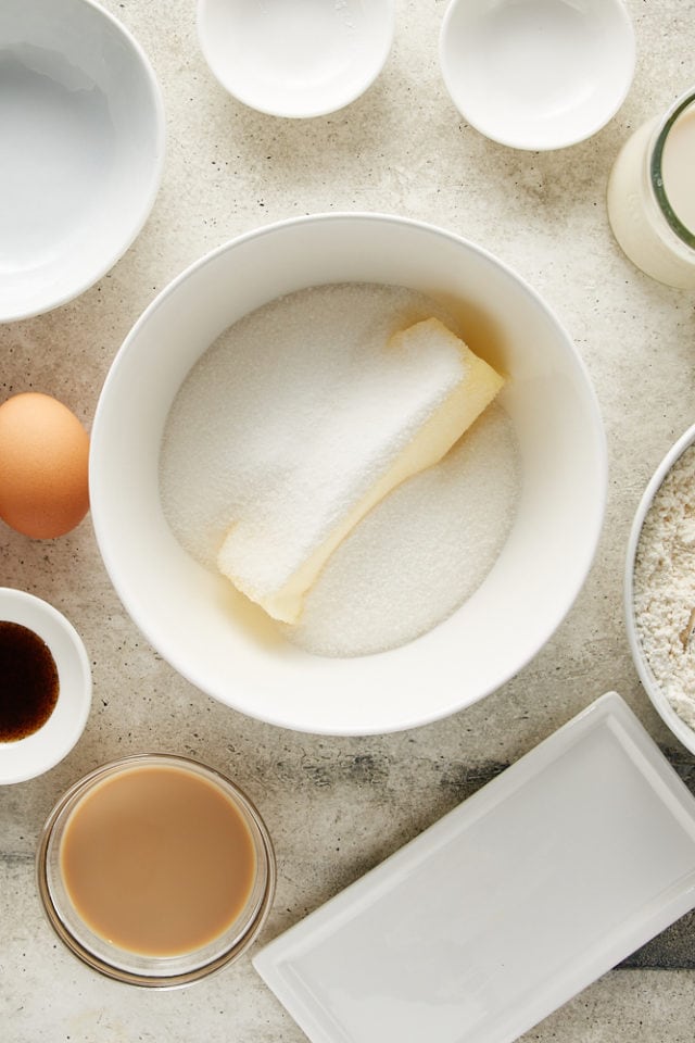 overhead view of butter and sugar in a white mixing bowl