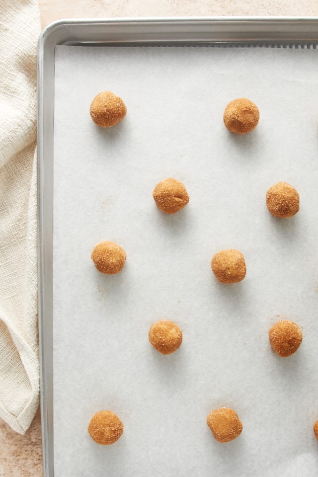 overhead view of White Chocolate Snickerdoodles cookie dough on a parchment-lined baking sheet ready to be baked