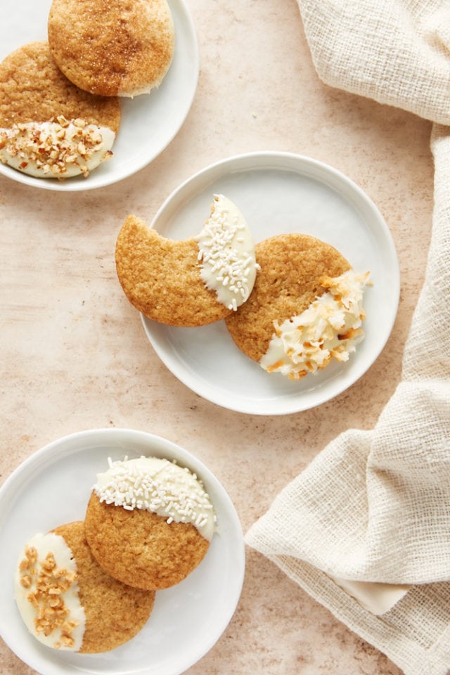 overhead view of three small white plates with White Chocolate Snickerdoodles on each