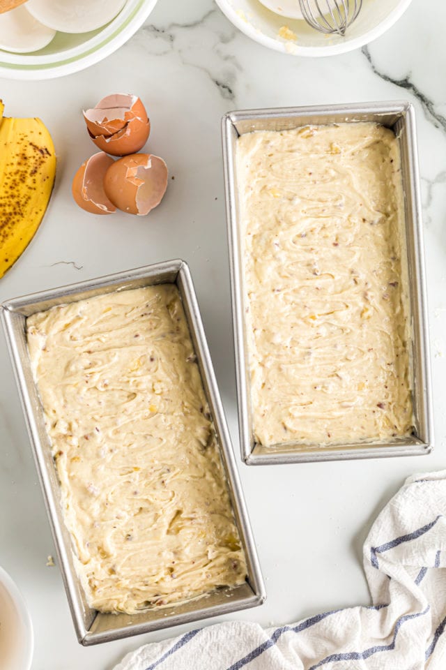 Overhead view of banana bread batter in loaf pans