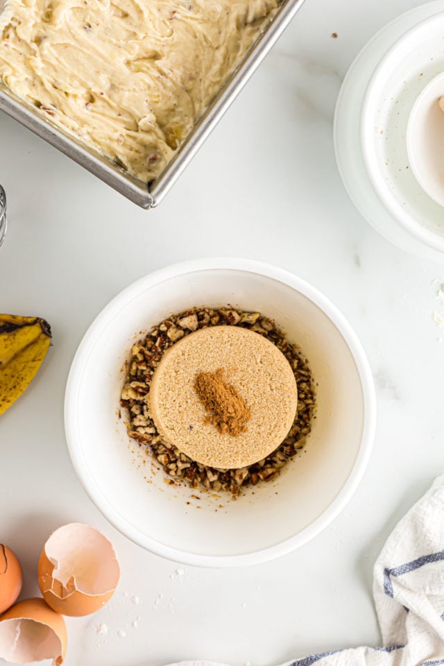 Overhead view of banana bread topping ingredients in white bowl