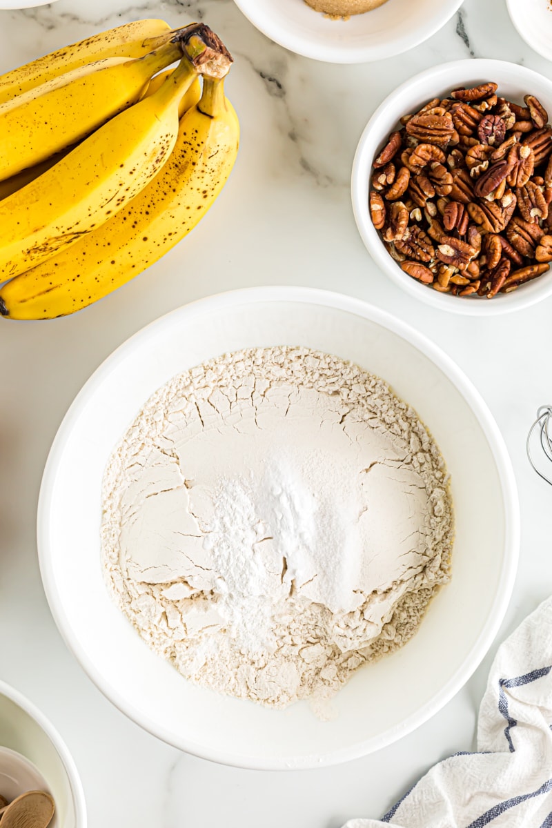 Overhead view of dry ingredients in white mixing bowl