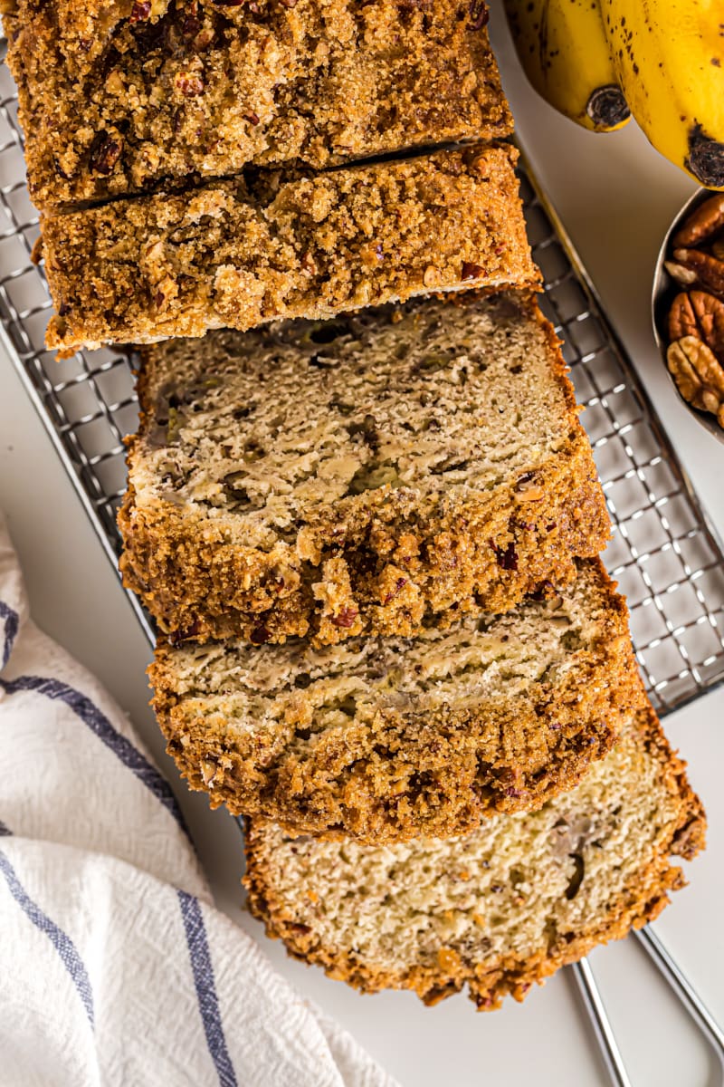 Overhead view of sliced cream cheese banana nut bread on wire rack