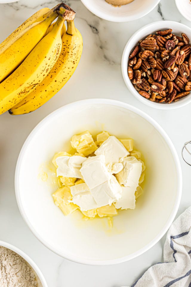 Overhead view of butter and cream cheese in mixing bowl