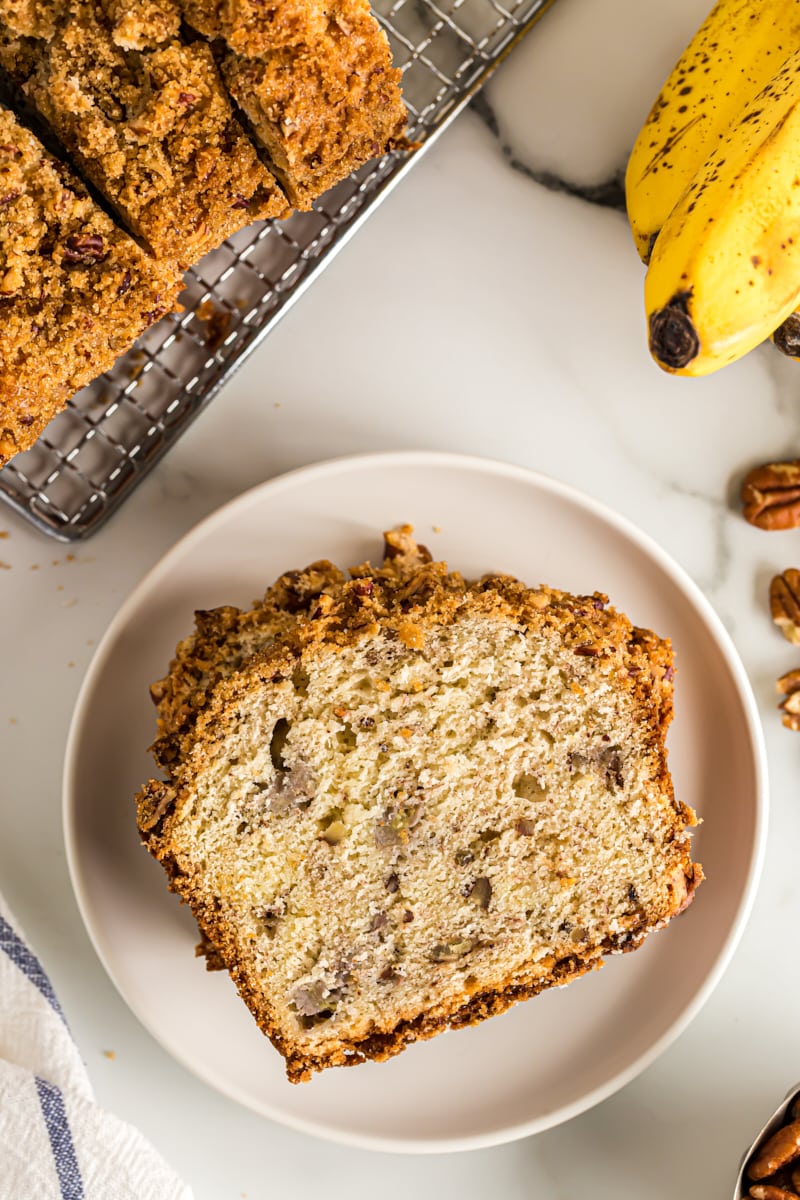 Overhead view of banana bread on white plate