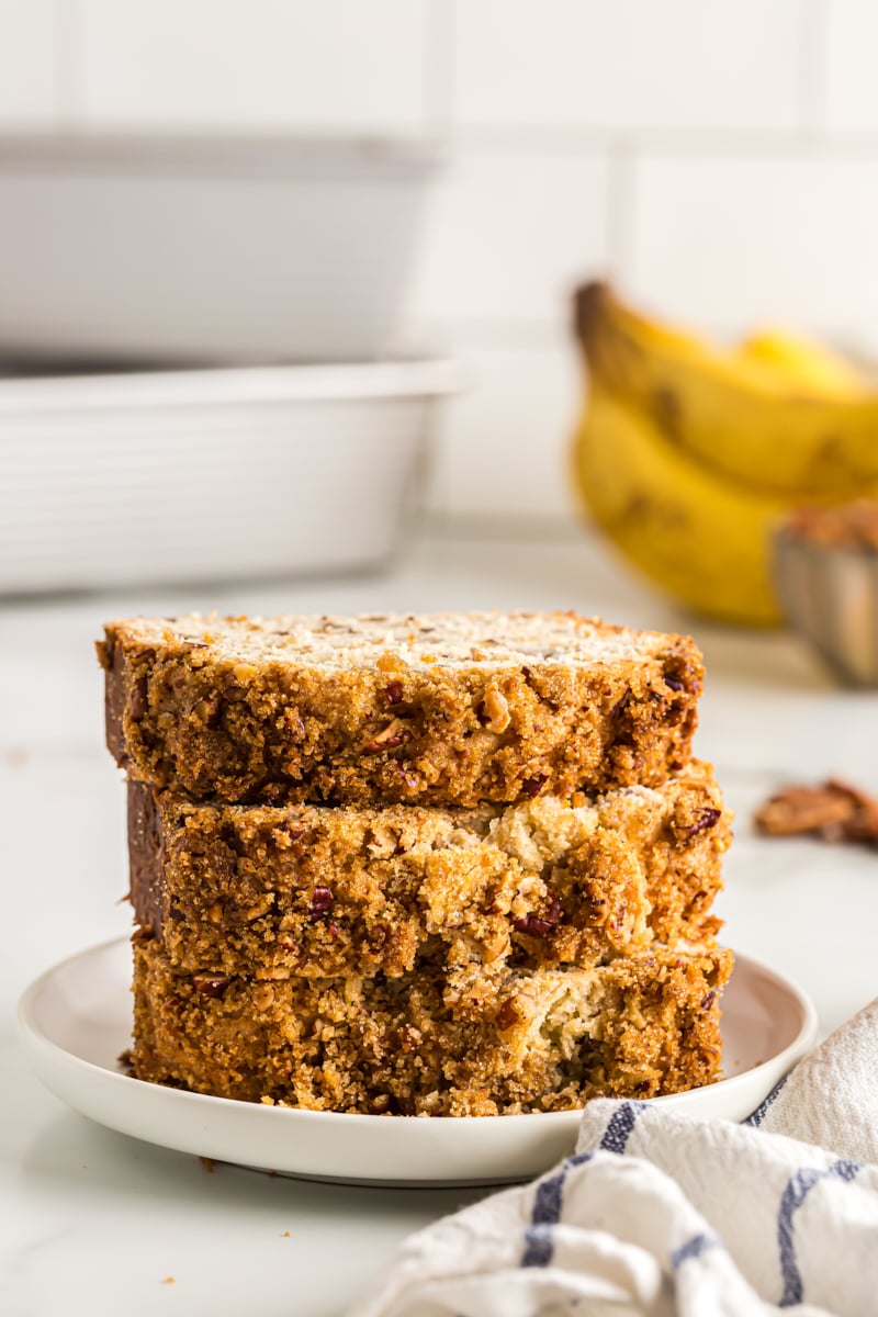 Stack of 3 banana bread slices on white plate