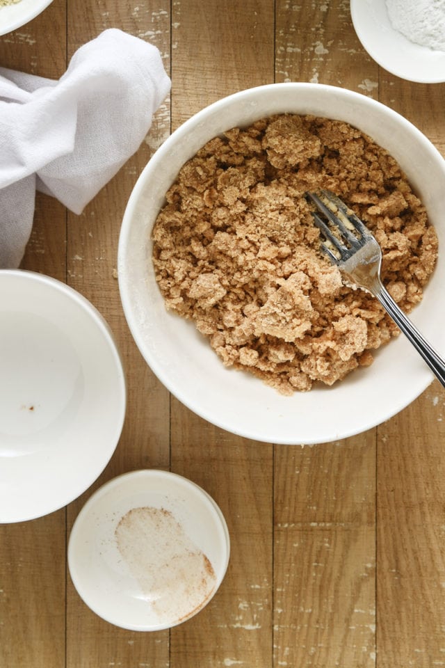 overhead view of crumb topping mixture in a white mixing bowl