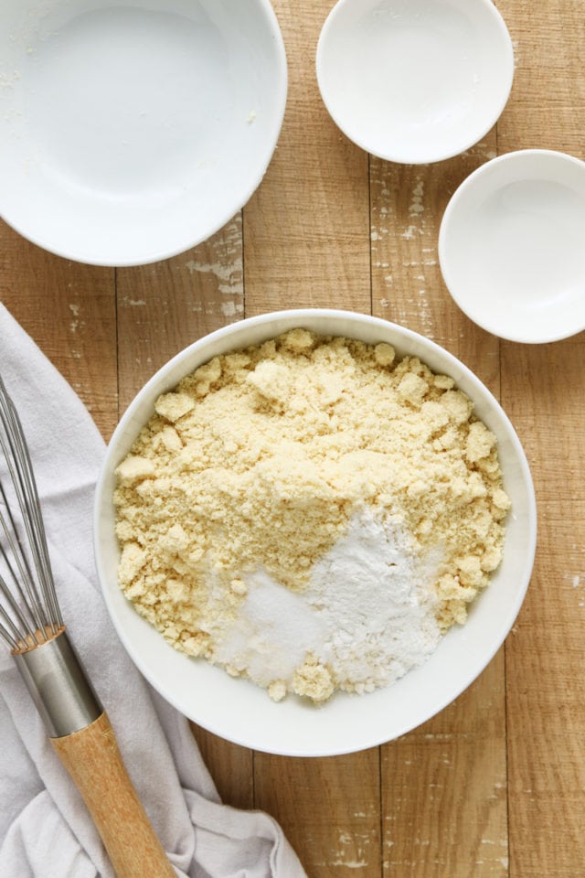 overhead view of flour, almond flour, baking powder, and salt in a white mixing bowl