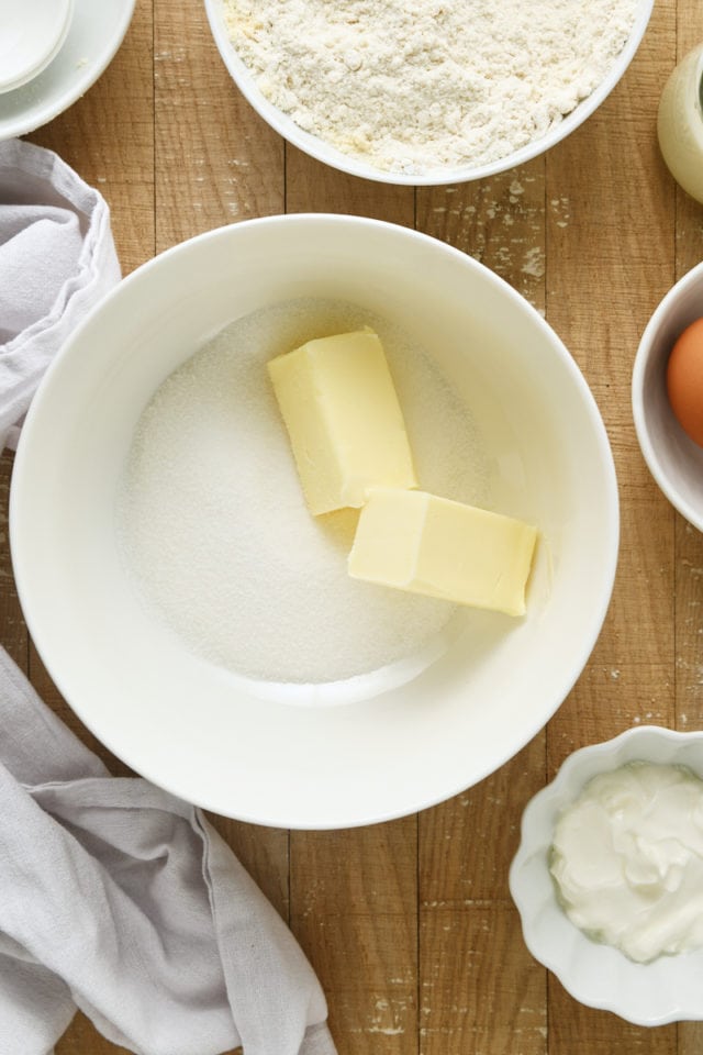 overhead view of butter and sugar in a white mixing bowl