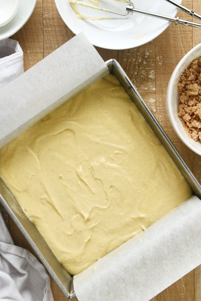overhead view of Almond Crumb Cake batter in a parchment-lined square baking pan