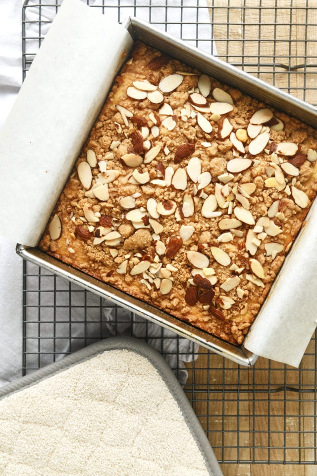 overhead view of freshly baked Almond Crumb Cake on a wire cooling rack