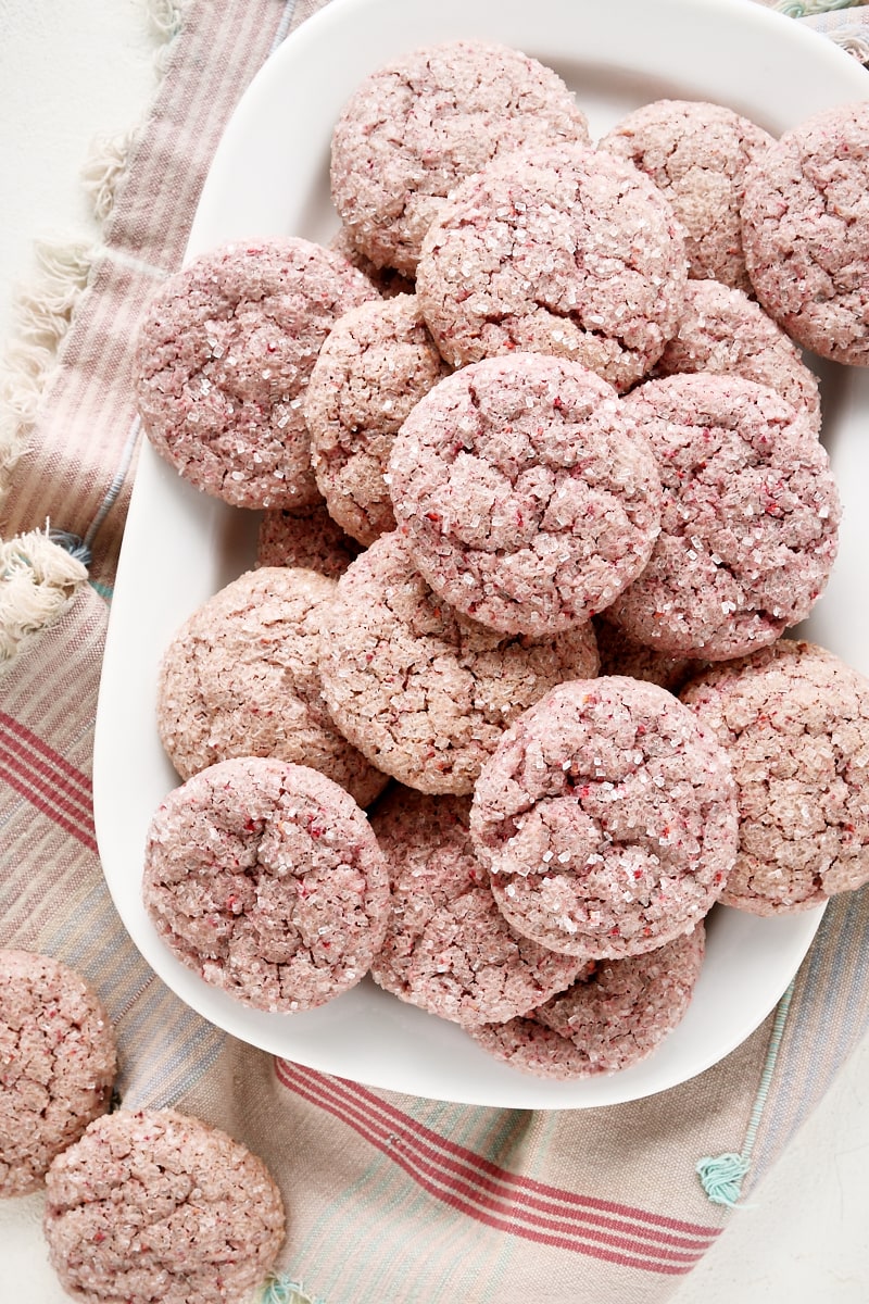 Overhead view of raspberry sugar cookies on a white tray.