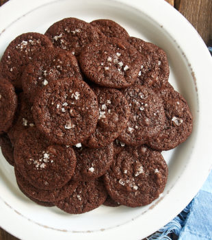 overhead view of Salted Double Chocolate Cookies piled on a white plate