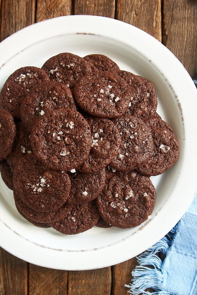 overhead view of Salted Double Chocolate Cookies piled on a white plate