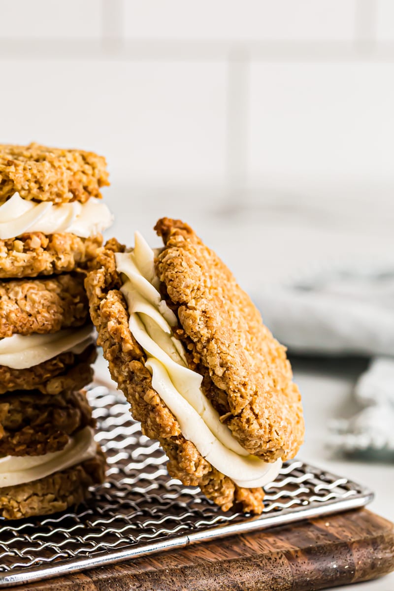 Oatmeal cream pie leaning against stack of pies on cooling rack