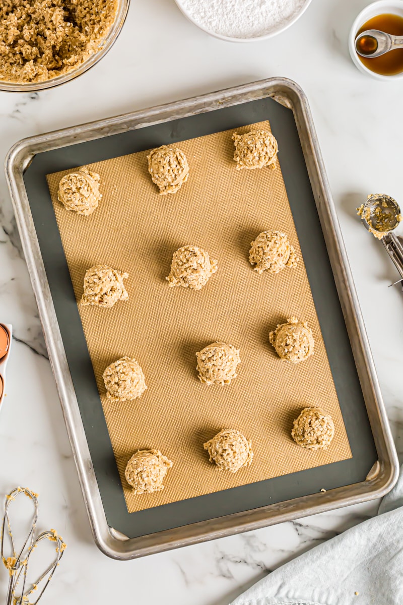 Overhead view of cookie dough on silicone-lined baking sheet