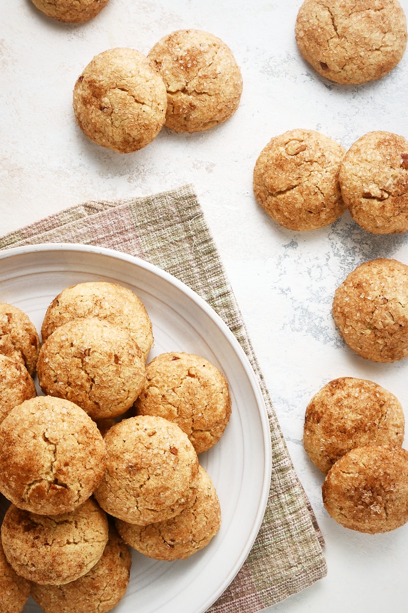 overhead view of Brown Butter Cinnamon Cookies on a light gray plate with more cookies scattered around