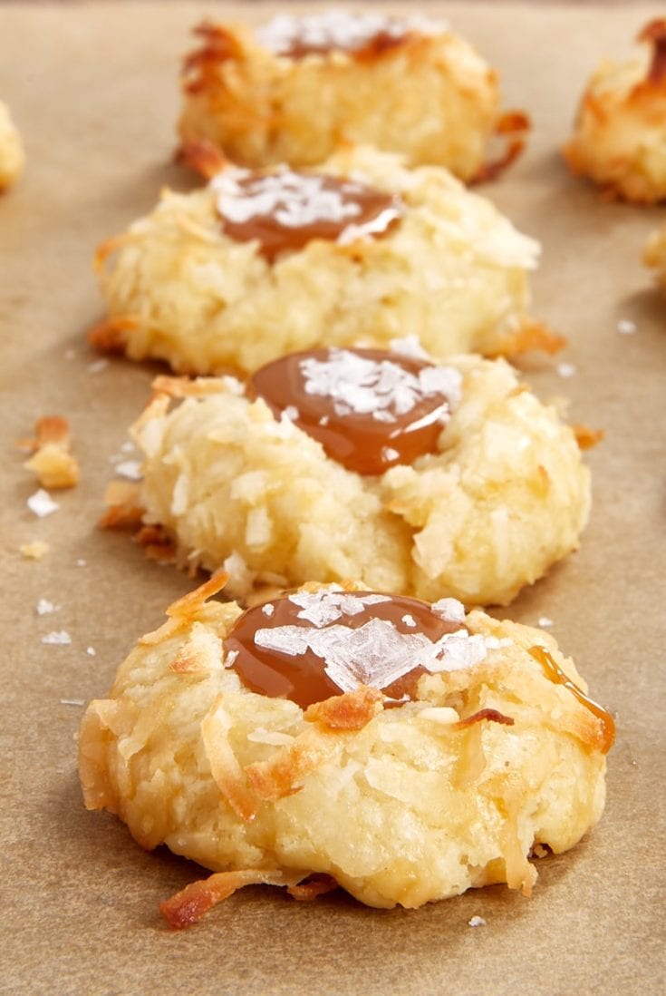 Coconut-Salted Caramel Thumbprint Cookies on parchment paper
