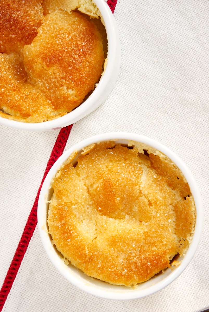 overhead view of two Meyer Lemon Pudding Cakes in white ramekins