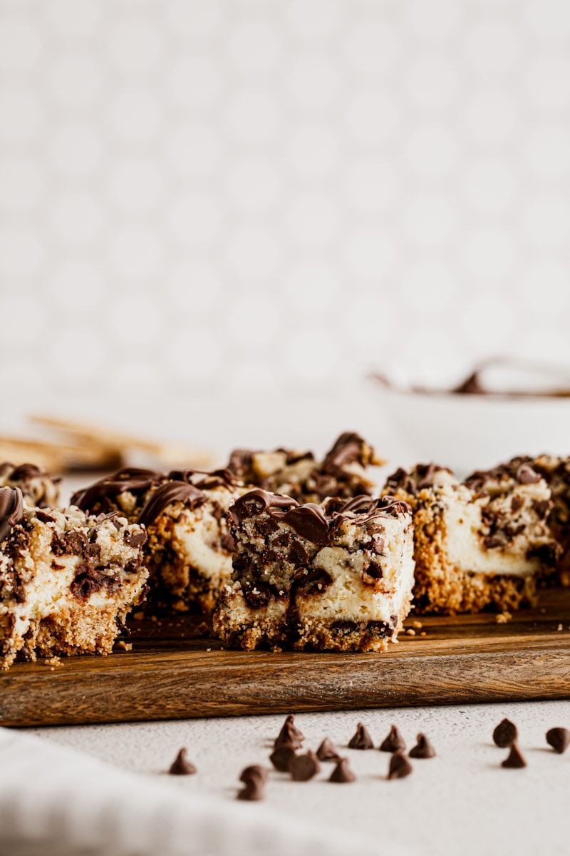Chocolate chip cookie dough cheesecake bars on cutting board