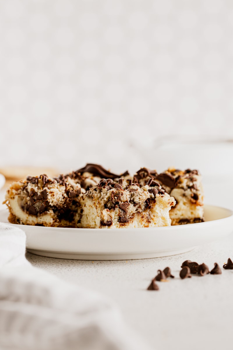 Side view of cookie dough cheesecake bars on plate
