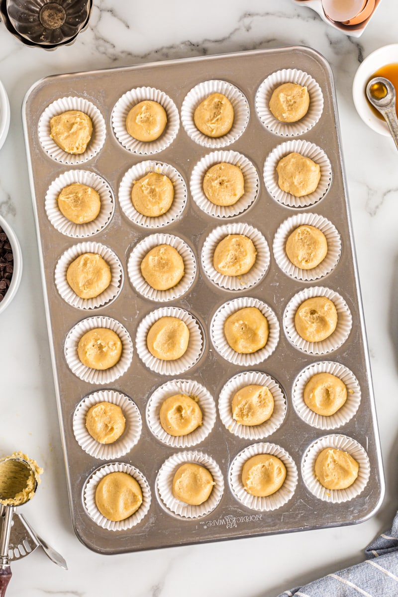 Overhead view of chocolate chip cupcake base in muffin tin