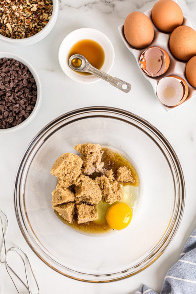 Brown sugar and egg in glass mixing bowl