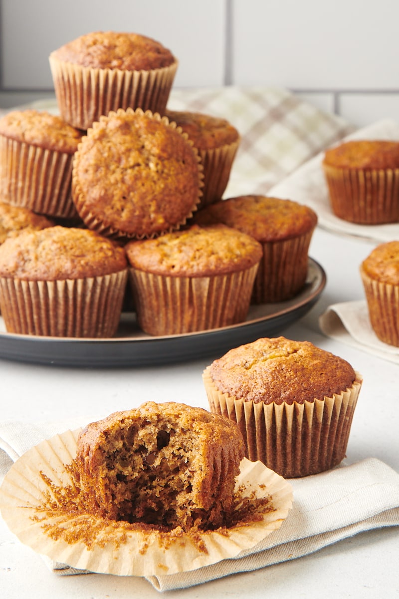 A partial banana nut muffin surrounded by more muffins.