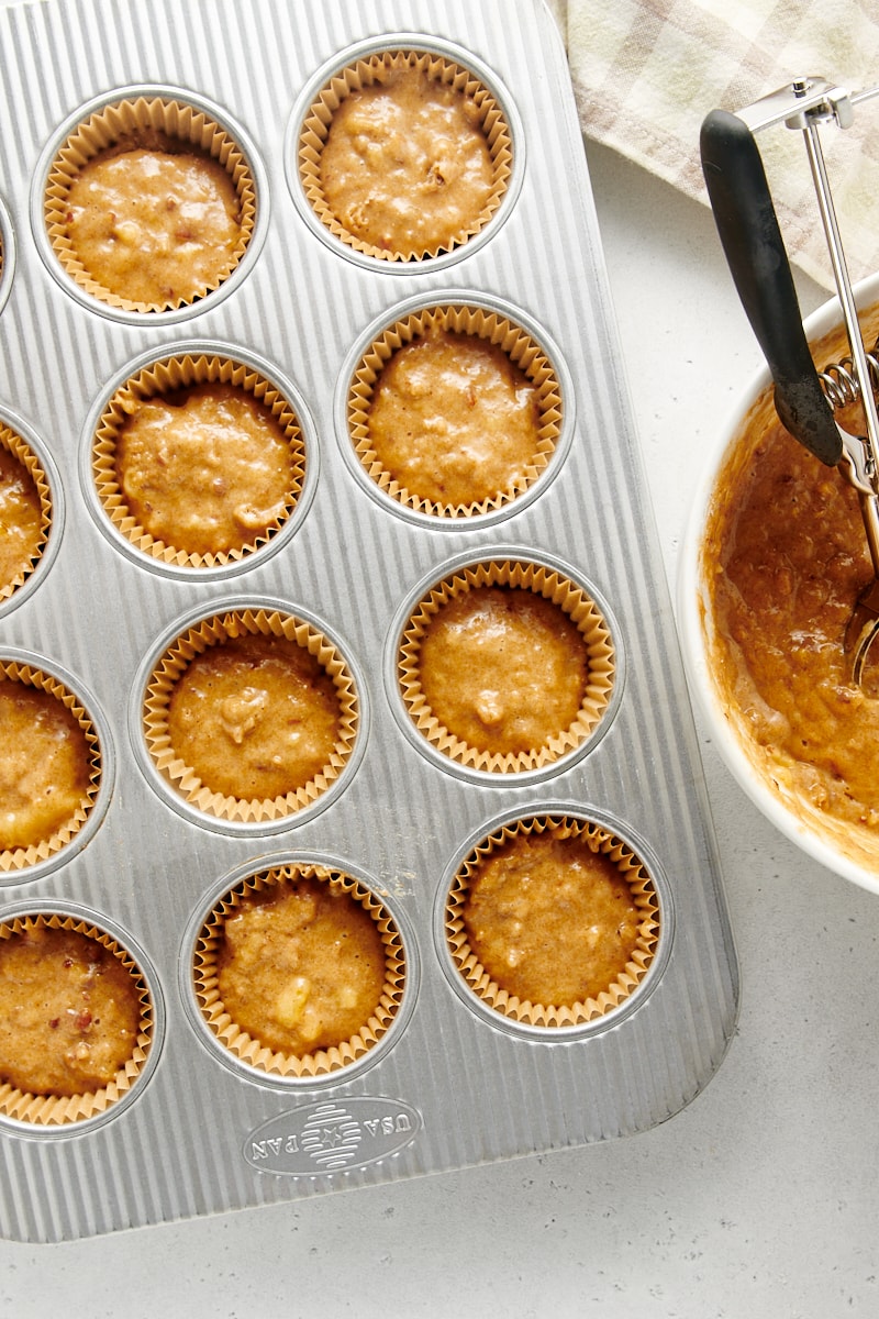 overhead view of banana nut muffin batter in a muffin pan