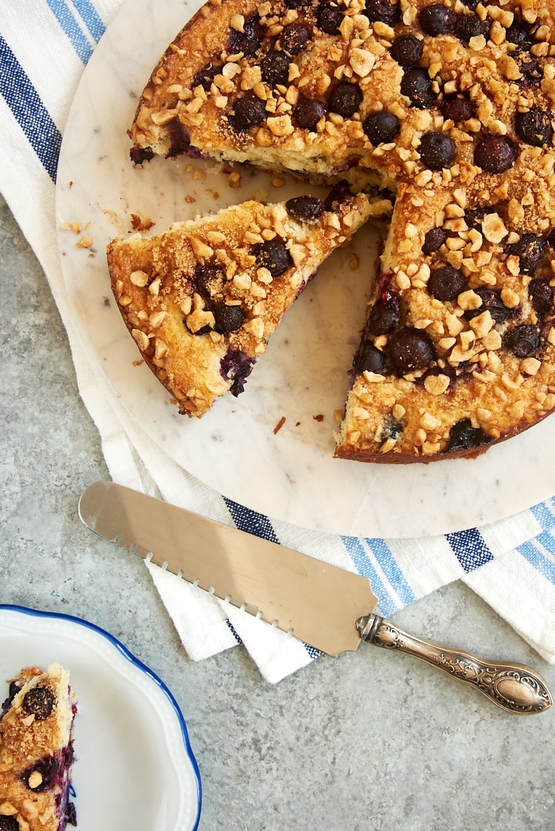 overhead view of partially sliced Blueberry Coffee Cake on a marble cake plate