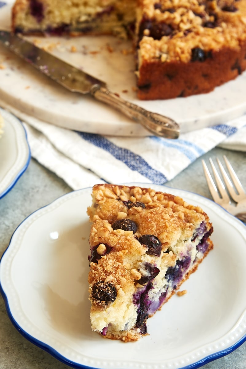 a slice of Blueberry Coffee Cake on a white plate