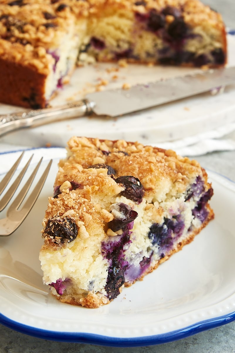 slice of Blueberry Coffee Cake on a blue-rimmed white plate