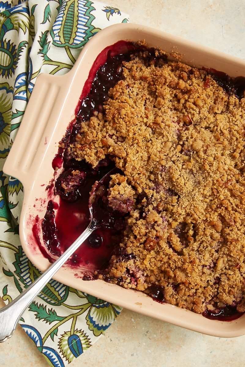 Cherry Berry Crumble in square baking dish with spoon