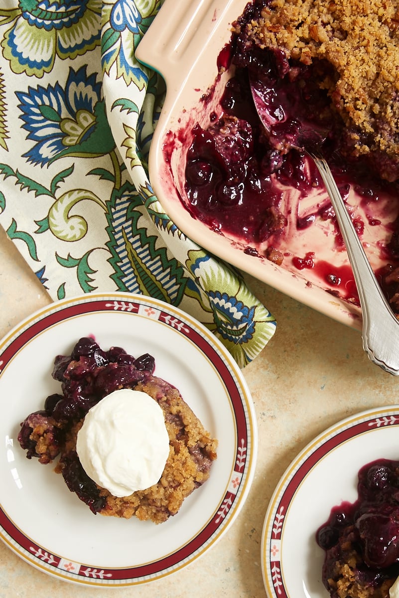 overhead view of Cherry Berry Crumble served with whipped cream and in a stone baker