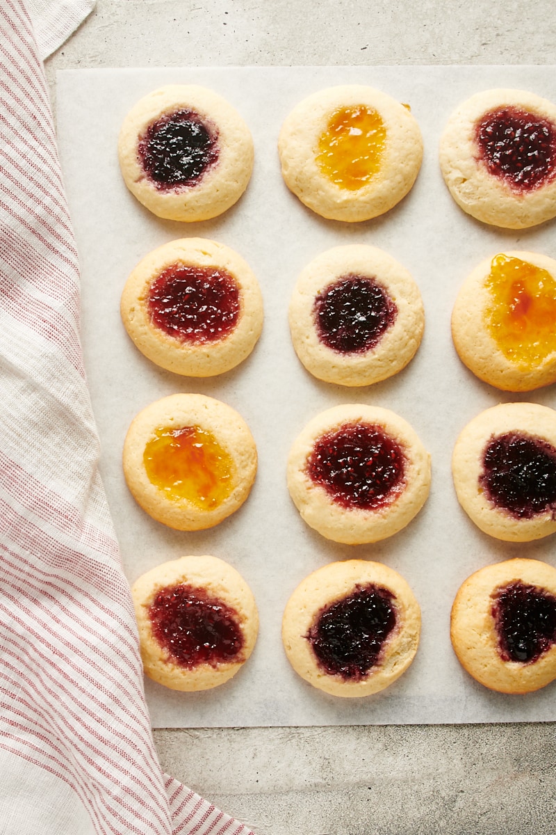 overhead view of Cream Cheese Thumbprint Cookies on white parchment paper