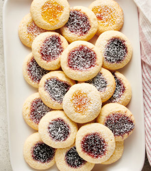 overhead view of jam-filled Cream Cheese Thumbprint Cookies on a white tray