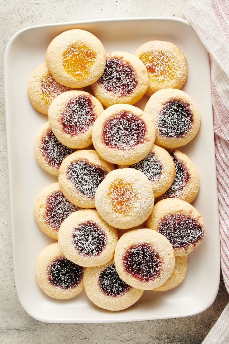 overhead view of jam-filled Cream Cheese Thumbprint Cookies on a white tray