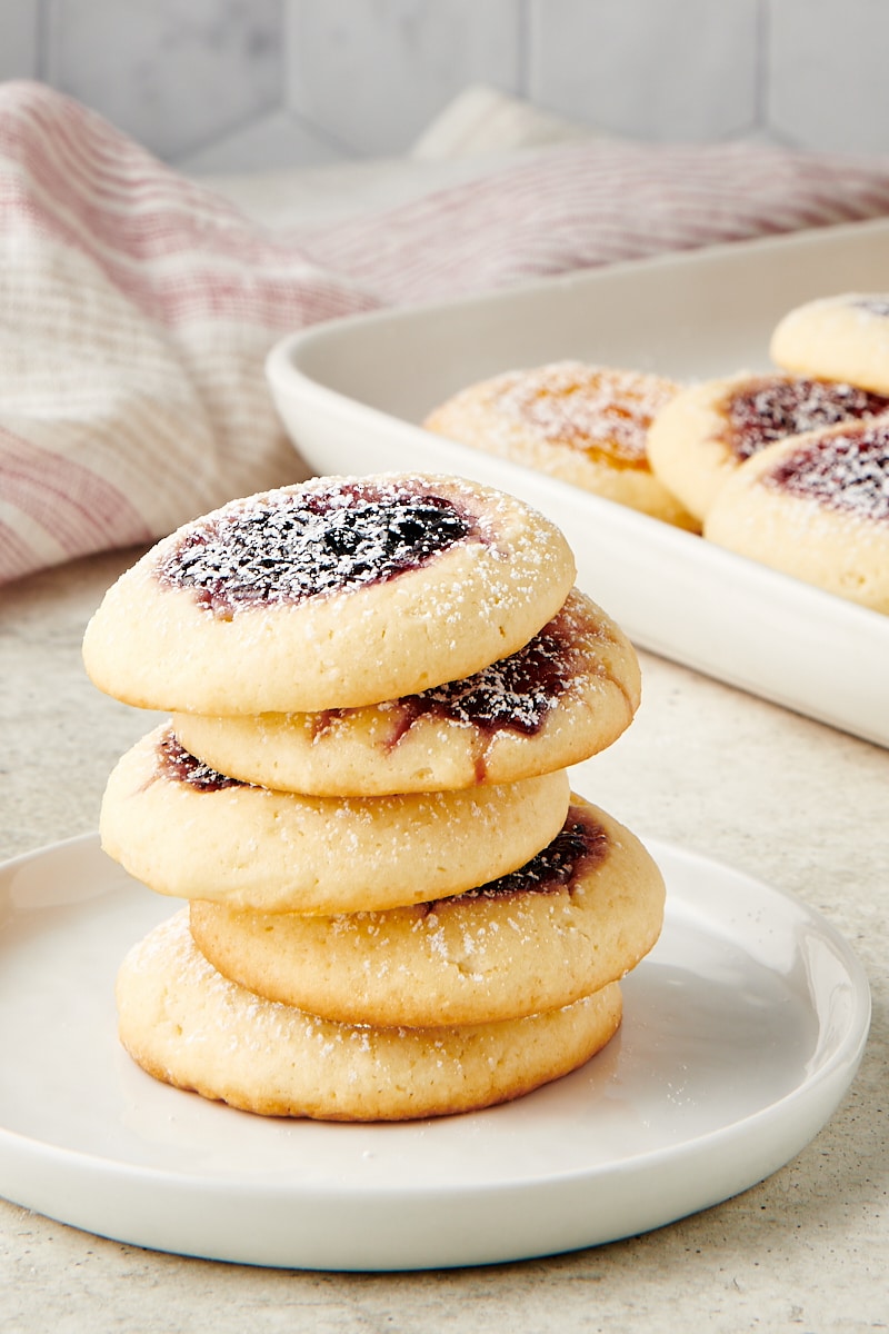 stack of Cream Cheese Thumbprint Cookies on a white plate