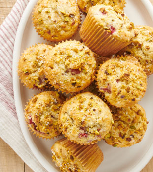 overhead view of Raspberry Pistachio Muffins on a white oval plate