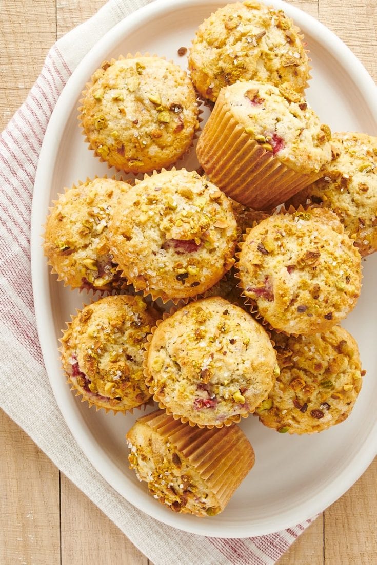 overhead view of Raspberry Pistachio Muffins on a white oval plate